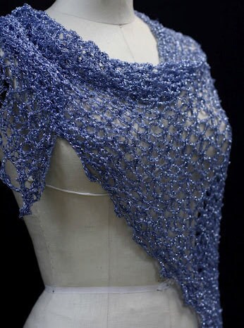 Blue shawl on a mannequin's torso, front view of the sparkling wrap.