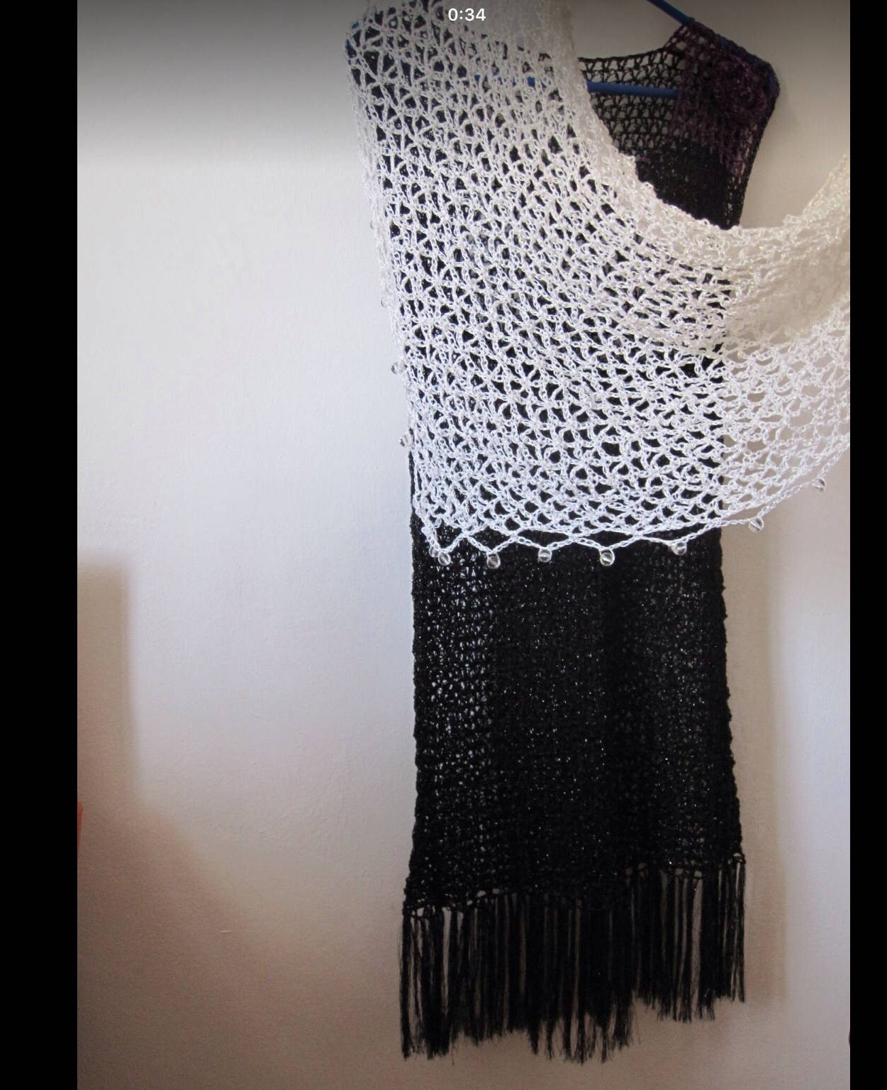 Cream shawl over a black dress, side view showing how the lightweight wrap drapes.