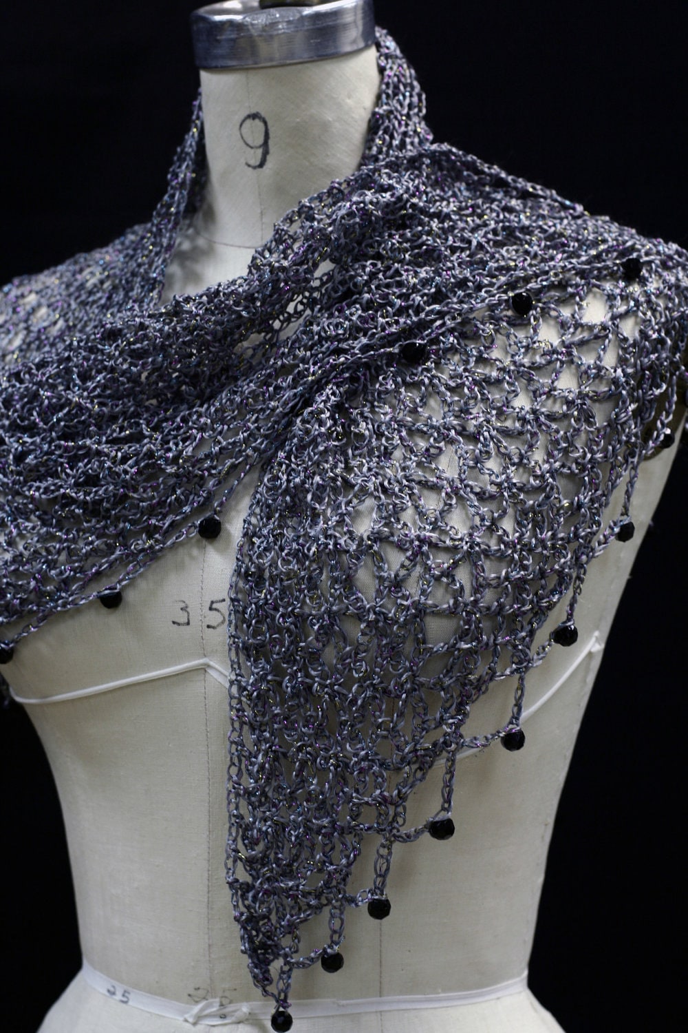 Grey shawl on the mannequin, alternate front angle showing the openwork and bead trim.