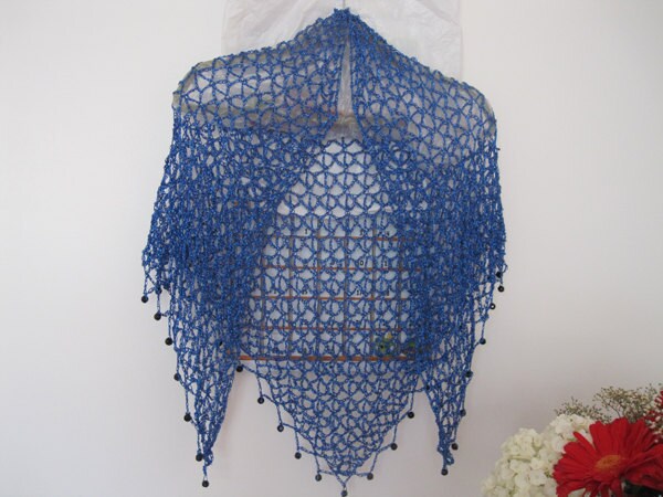 Sapphire blue shawl hanging centered, full front view of the openwork wrap.