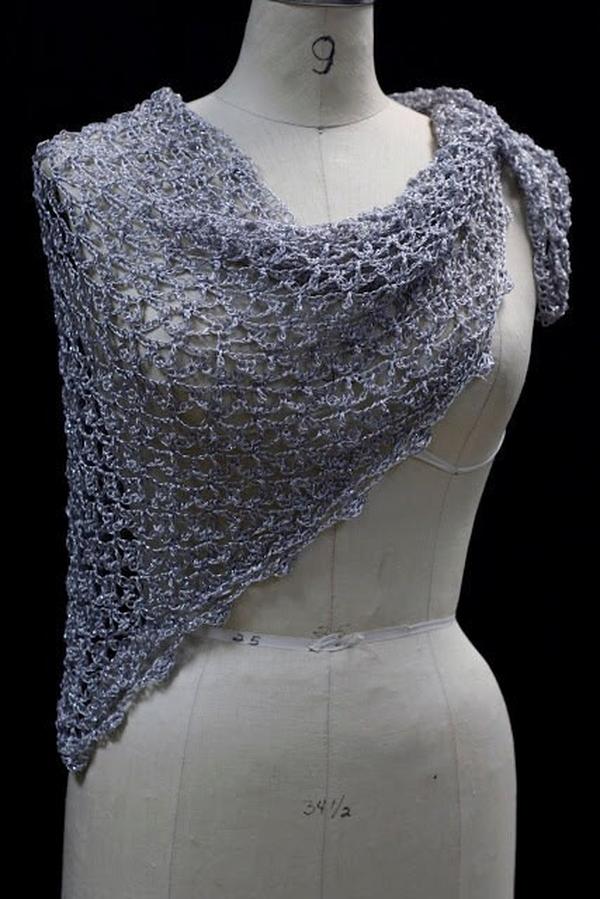 Lightweight silver-white shawl draped on a dress-form mannequin against a dark background, front three-quarter view.