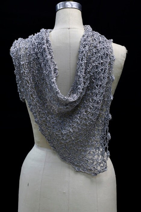 Back view of the silver-white bridal shawl on the mannequin, the wrap falling softly down the back.