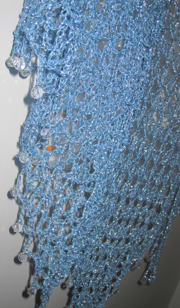 Close-up of the sky blue shawl's beaded edge, clear beads set along the scalloped trim.