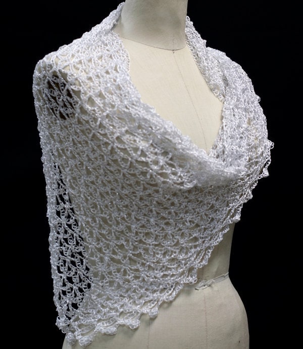 White wedding shawl draped on a dress-form mannequin, front three-quarter view of the delicate wrap.